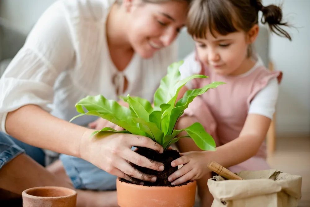 a mother and daughter pot a plant for their kid-friendly activity in New Braunfels